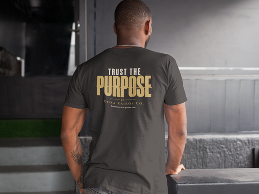 Man wearing Doxa Kairos Co. “Trust the Purpose” t-shirt representing resilience, identity, and purpose-driven apparel.